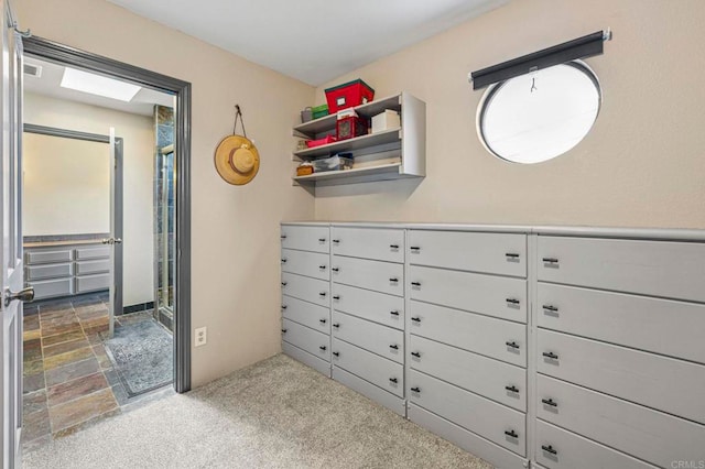 interior space featuring visible vents, stone finish floor, and carpet