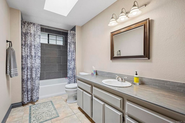 bathroom with vanity, shower / bath combination with curtain, toilet, tile patterned floors, and a skylight