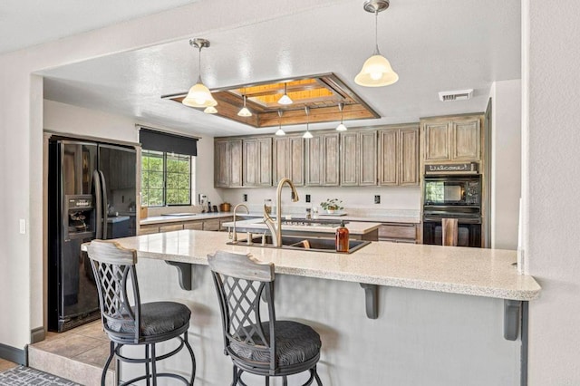 3223 Olive Hill Rd, Fallbrook, CA 92028 - kitchen featuring light stone counters, black appliances, visible vents, pendant lighting, and a kitchen bar