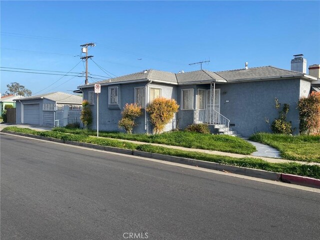 8802 S Wilton Pl, Los Angeles, CA 90047 - ranch-style house featuring stucco siding, an outdoor structure, and a chimney