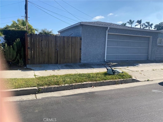 8802 S Wilton Pl, Los Angeles, CA 90047 - view of property exterior with stucco siding and fence