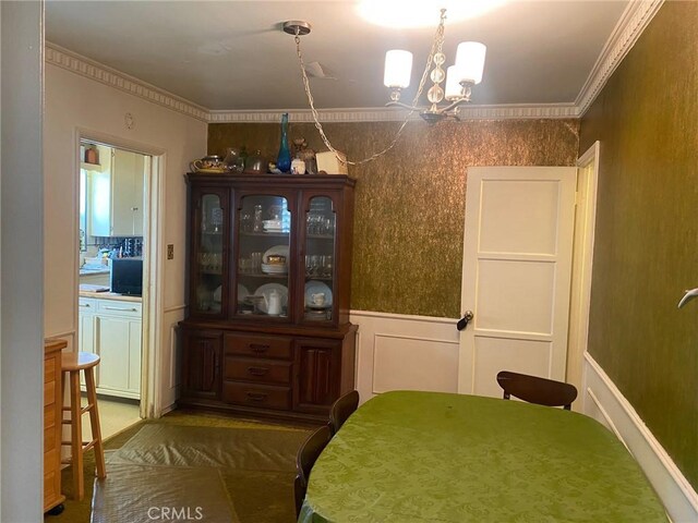 8802 S Wilton Pl, Los Angeles, CA 90047 - dining space featuring a chandelier and ornamental molding