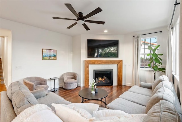 living area with baseboards, a ceiling fan, recessed lighting, wood finished floors, and a tile fireplace