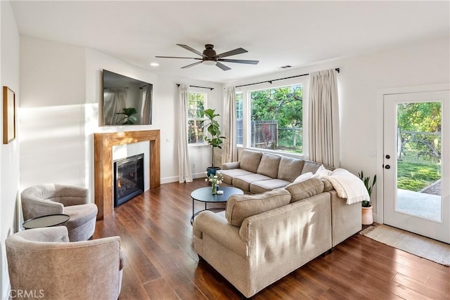 living room with dark wood-style flooring, ceiling fan, a glass covered fireplace, and recessed lighting