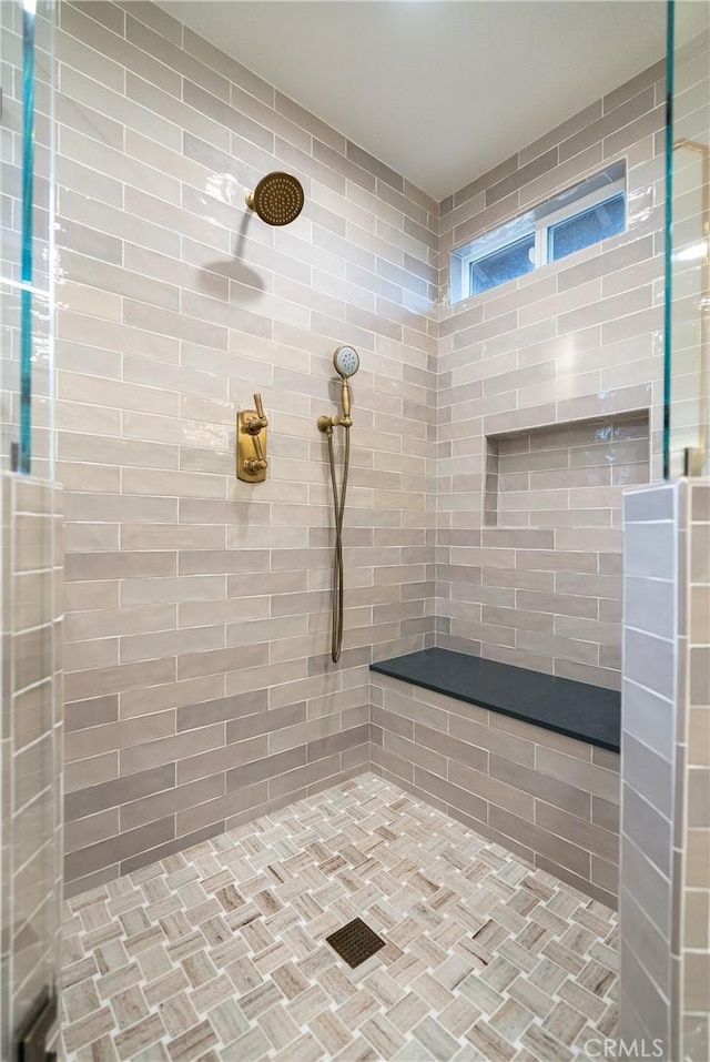 full bathroom with tiled shower