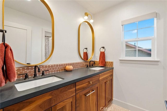 full bathroom featuring double vanity, baseboards, a sink, and decorative backsplash
