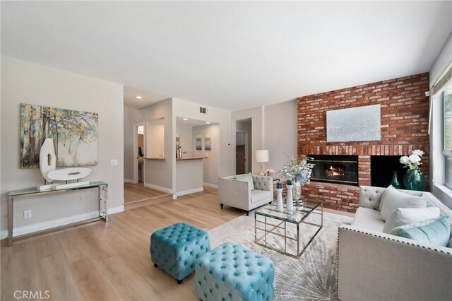 4930 Rockhampton Ct, Yorba Linda, CA 92887 - living area with visible vents, wood finished floors, baseboards, and a brick fireplace