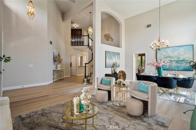 4930 Rockhampton Ct, Yorba Linda, CA 92887 - living area featuring visible vents, wood finished floors, stairway, and a notable chandelier