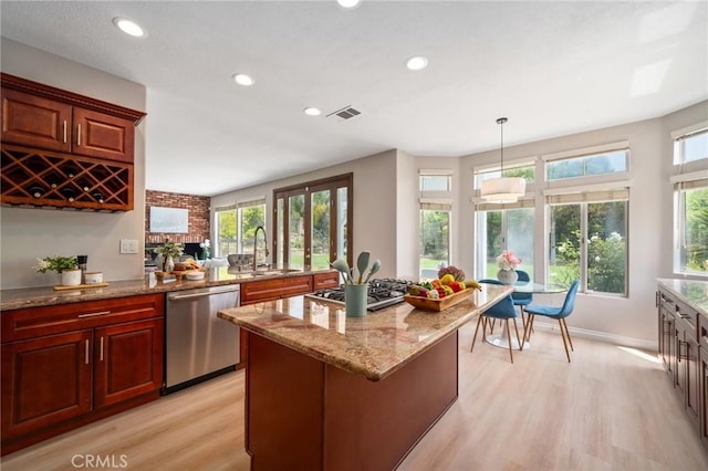 4930 Rockhampton Ct, Yorba Linda, CA 92887 - kitchen with light stone counters, visible vents, a sink, stainless steel appliances, and light wood-type flooring