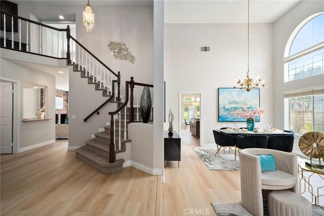 4930 Rockhampton Ct, Yorba Linda, CA 92887 - foyer featuring a wealth of natural light, an inviting chandelier, a towering ceiling, and wood finished floors