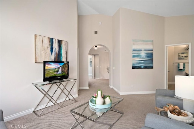 4930 Rockhampton Ct, Yorba Linda, CA 92887 - carpeted living room with visible vents, baseboards, a towering ceiling, and arched walkways