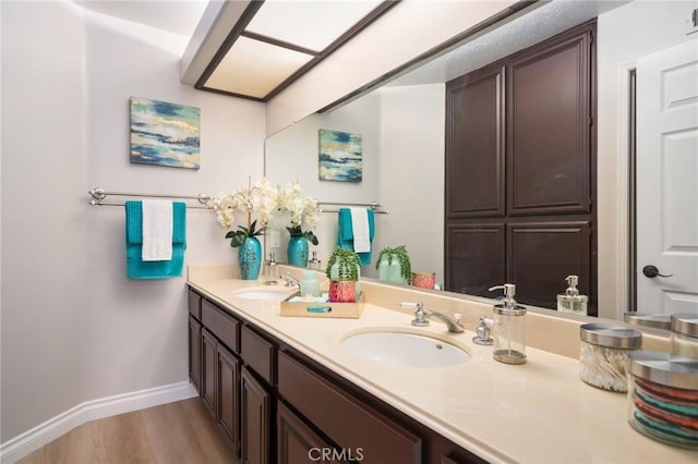 4930 Rockhampton Ct, Yorba Linda, CA 92887 - full bath with baseboards, double vanity, a sink, and wood finished floors