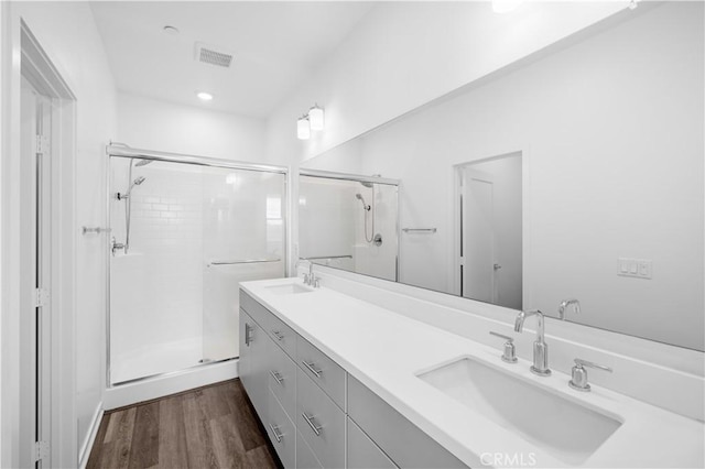 225 Scratch Rd, Covina, CA 91722 - bathroom featuring a stall shower, wood finished floors, double vanity, and recessed lighting