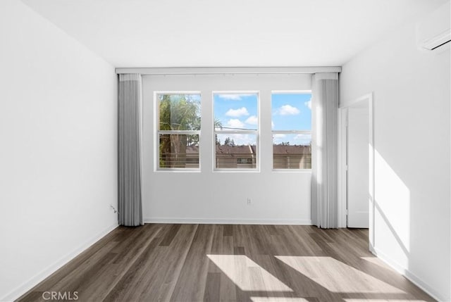 225 Scratch Rd, Covina, CA 91722 - unfurnished room with wood finished floors, a wall mounted air conditioner, and baseboards