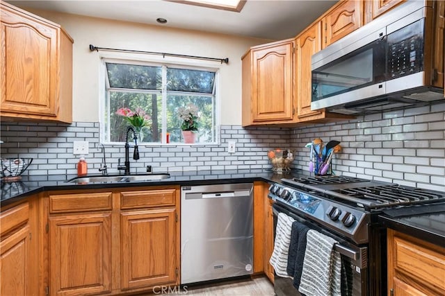 23747 Bowl Rd, Crestline, CA 92325 - kitchen with backsplash, stainless steel appliances, dark countertops, and a sink