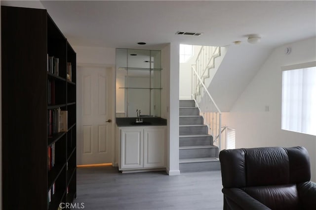 interior space featuring stairs, visible vents, and wood finished floors