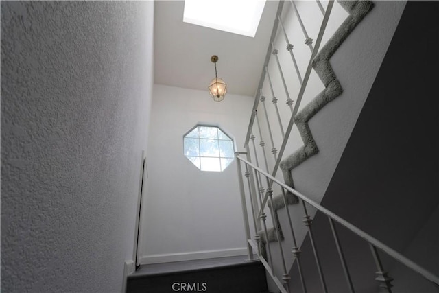 stairs featuring a textured wall