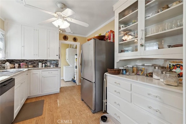 kitchen featuring light wood-type flooring, a sink, appliances with stainless steel finishes, and white cabinets