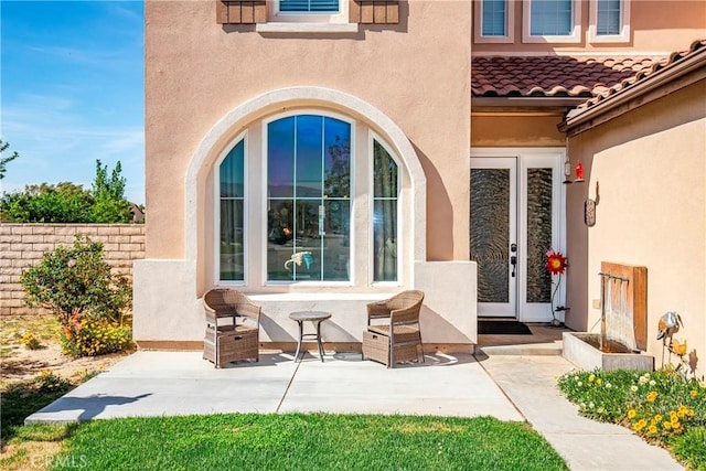 3565 Louer Dr, Lancaster, CA 93536 - doorway to property featuring stucco siding, a patio area, and a tile roof
