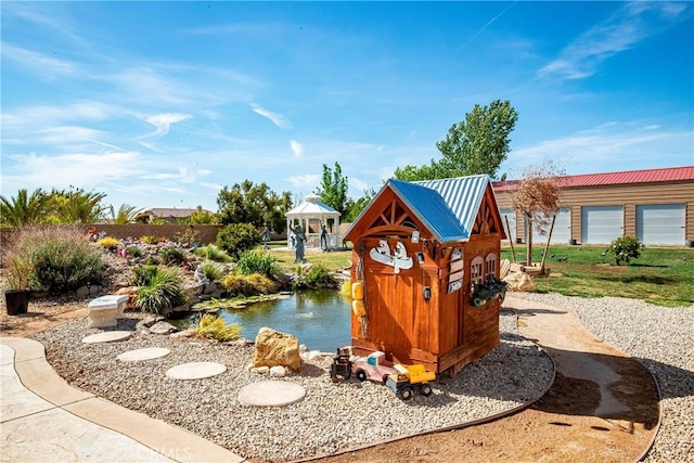 3565 Louer Dr, Lancaster, CA 93536 - view of jungle gym featuring a small pond and a gazebo
