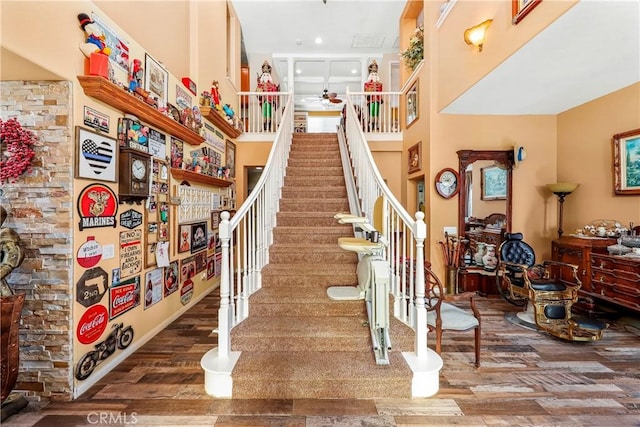 3565 Louer Dr, Lancaster, CA 93536 - staircase with a towering ceiling, a ceiling fan, and wood finished floors