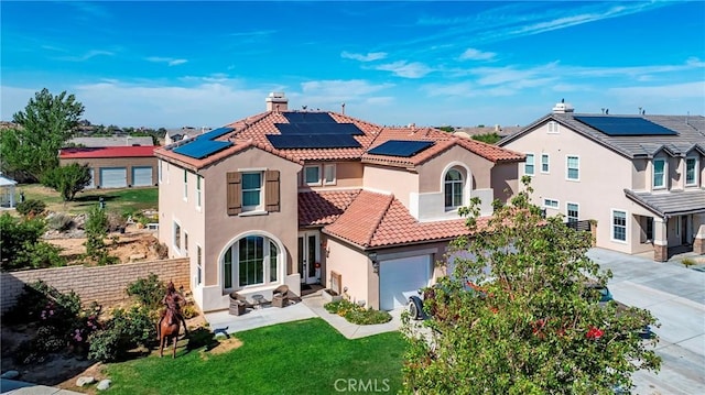 3565 Louer Dr, Lancaster, CA 93536 - mediterranean / spanish house with fence, a tile roof, a front yard, solar panels, and stucco siding