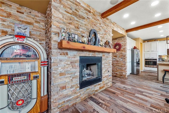 3565 Louer Dr, Lancaster, CA 93536 - living room featuring recessed lighting, beam ceiling, wood finished floors, and a fireplace