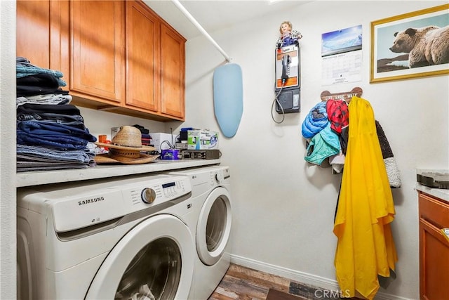 3565 Louer Dr, Lancaster, CA 93536 - laundry area featuring wood finished floors, washing machine and clothes dryer, cabinet space, and baseboards