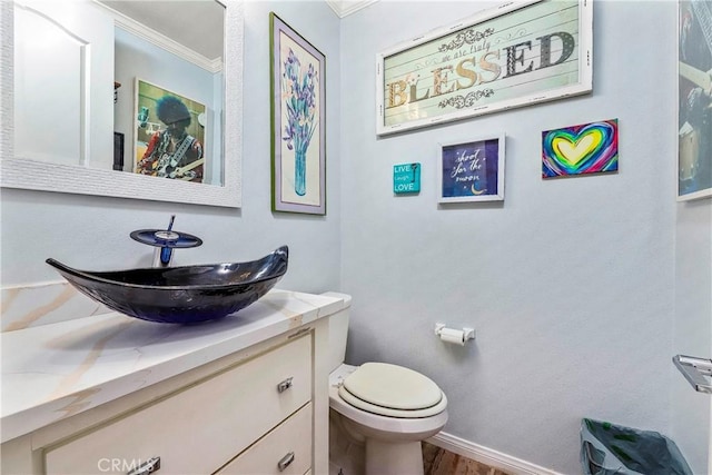 3565 Louer Dr, Lancaster, CA 93536 - bathroom featuring baseboards, toilet, ornamental molding, wood finished floors, and vanity