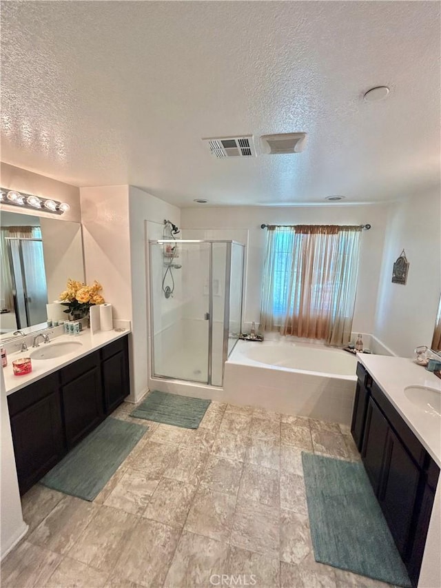 6974 Canterra Way, Fontana, CA 92336 - full bath featuring a textured ceiling, a shower stall, two vanities, and a bath