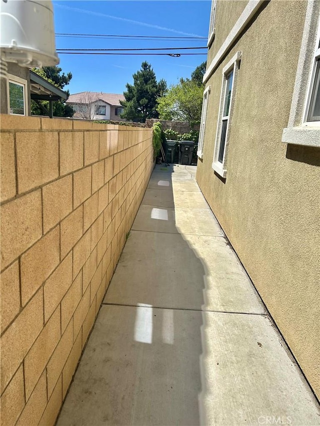 6974 Canterra Way, Fontana, CA 92336 - view of side of home with a patio area and stucco siding