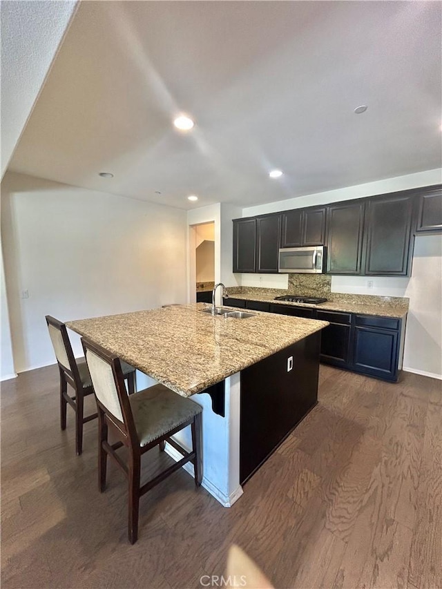 6974 Canterra Way, Fontana, CA 92336 - kitchen featuring stainless steel microwave, dark wood-style flooring, light stone counters, gas stovetop, and recessed lighting