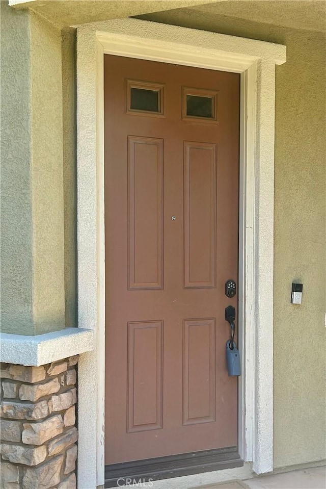 6974 Canterra Way, Fontana, CA 92336 - doorway to property featuring stucco siding