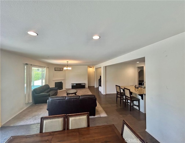 6974 Canterra Way, Fontana, CA 92336 - living area featuring recessed lighting, a fireplace, and a chandelier