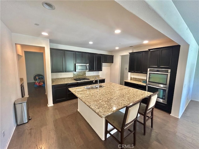 6974 Canterra Way, Fontana, CA 92336 - kitchen featuring appliances with stainless steel finishes, dark wood-style floors, dark cabinetry, and recessed lighting