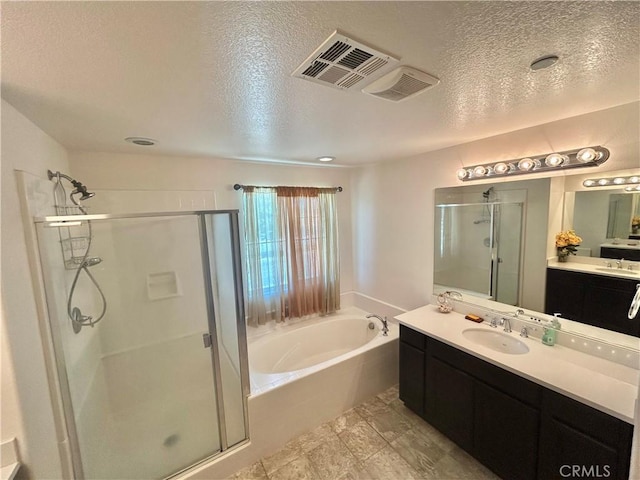 6974 Canterra Way, Fontana, CA 92336 - bathroom featuring a shower stall, a textured ceiling, a bath, and vanity