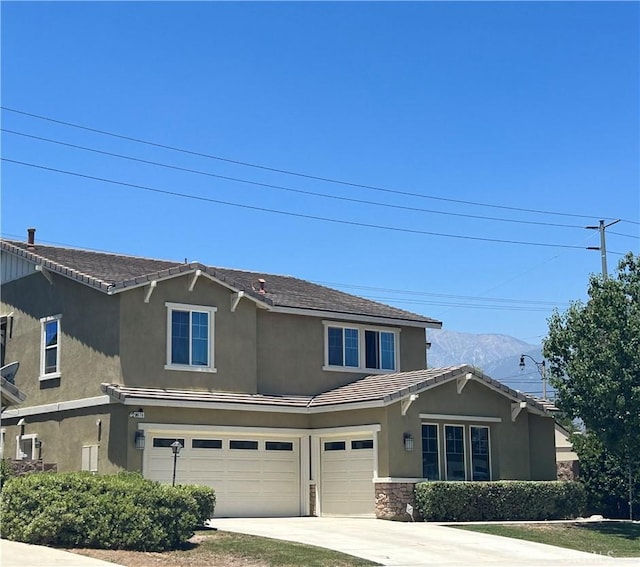 6974 Canterra Way, Fontana, CA 92336 - view of front of home featuring a garage, driveway, stucco siding, a mountain view, and stone siding