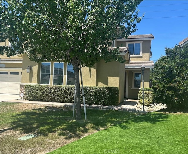 6974 Canterra Way, Fontana, CA 92336 - view of front facade with stucco siding, a front yard, and a garage