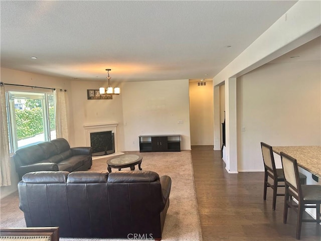 6974 Canterra Way, Fontana, CA 92336 - living area with a fireplace, a chandelier, and dark wood-style flooring