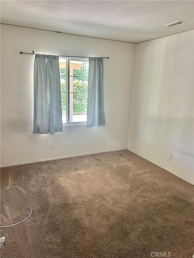 6974 Canterra Way, Fontana, CA 92336 - empty room featuring carpet and a textured ceiling