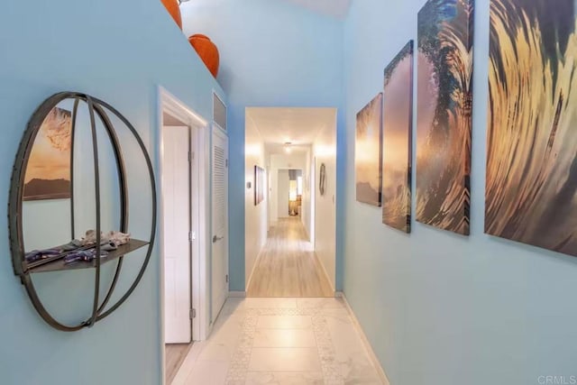 corridor featuring baseboards and visible vents