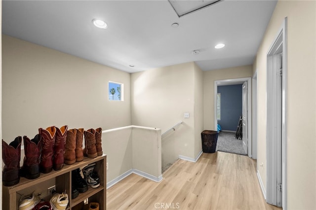 corridor featuring recessed lighting, baseboards, an upstairs landing, and light wood-style floors