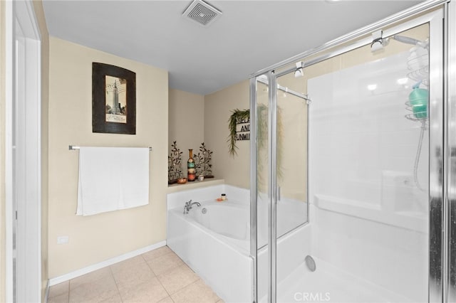 bathroom with tile patterned floors, a stall shower, a garden tub, and visible vents