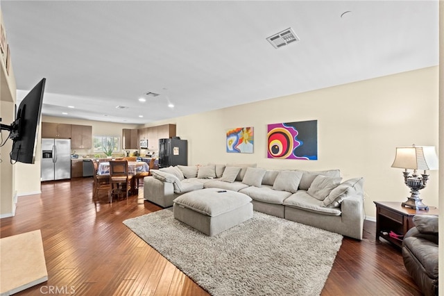 living area with recessed lighting, baseboards, visible vents, and dark wood-style floors