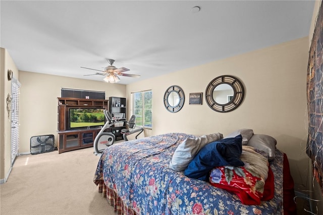 carpeted bedroom featuring baseboards and ceiling fan