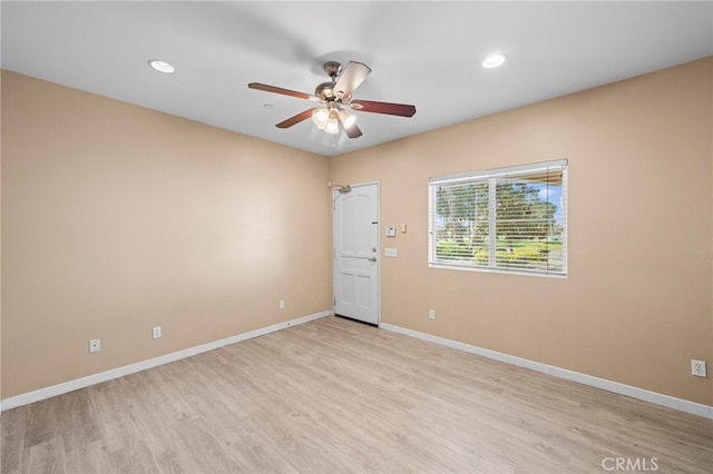 empty room featuring a ceiling fan, baseboards, recessed lighting, and light wood-type flooring