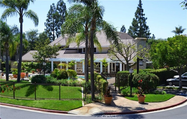 surrounding community with a yard and a fenced front yard