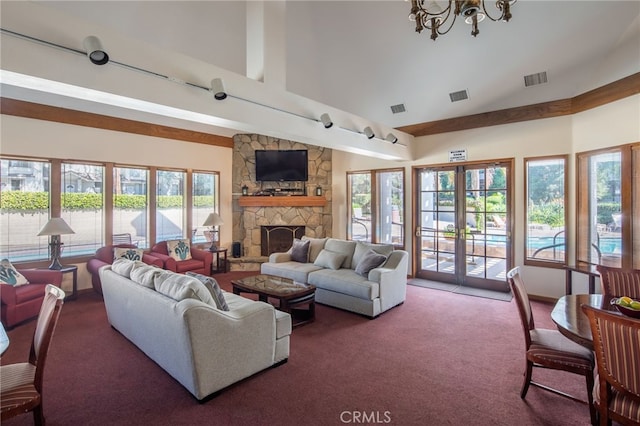carpeted living area with visible vents, high vaulted ceiling, and a fireplace