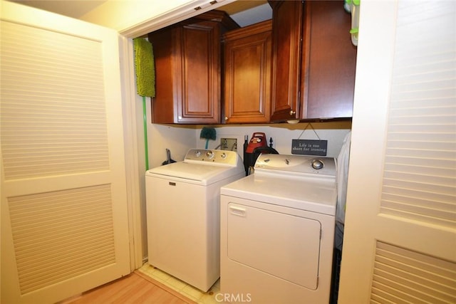 laundry area with cabinet space and washing machine and clothes dryer