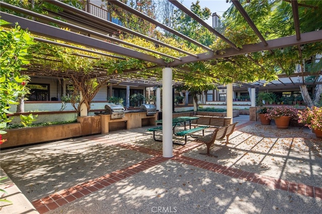 view of patio / terrace featuring a pergola, exterior kitchen, and area for grilling